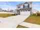 New construction home with a two-car garage, manicured lawn, and attractive curb appeal at 159 Tanner Loop, Troutman, NC 28166