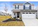 Charming two-story home featuring stone veneer, a two-car garage, and a well-maintained lawn at 159 Tanner Loop, Troutman, NC 28166