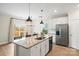 Modern kitchen with granite countertops, stainless steel appliances, and open layout to the dining area at 159 Tanner Loop, Troutman, NC 28166