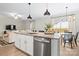 Stylish kitchen island with granite countertops, stainless steel appliances, and seating overlooking the living area at 159 Tanner Loop, Troutman, NC 28166