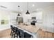Bright kitchen with white cabinets, granite countertops, stainless steel appliances, and a spacious island with barstool seating at 159 Tanner Loop, Troutman, NC 28166