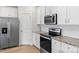 Kitchen featuring stainless steel appliances, granite countertops, and white cabinetry at 159 Tanner Loop, Troutman, NC 28166