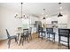 Bright kitchen features an island with bar seating and an adjacent dining area at 159 Tanner Loop, Troutman, NC 28166