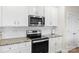 Well-equipped kitchen featuring stainless steel appliances, granite countertops, and white subway tile backsplash at 159 Tanner Loop, Troutman, NC 28166