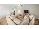 Bright living room with a large sectional sofa, ceiling fan, and view into the entry foyer at 159 Tanner Loop, Troutman, NC 28166