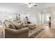 Open living room featuring a spacious sectional sofa, seamless kitchen access, and natural light at 159 Tanner Loop, Troutman, NC 28166