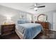 Main bedroom with a king-size bed, dark wood dresser, and ceiling fan at 1926 Hopewell Church Rd, Sherrills Ford, NC 28673
