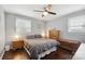 Bright bedroom with double bed, dark wood floors, and ceiling fan at 1926 Hopewell Church Rd, Sherrills Ford, NC 28673