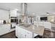 Modern kitchen with island, stainless steel appliances, and view to living room at 1926 Hopewell Church Rd, Sherrills Ford, NC 28673