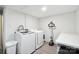 Basement laundry room with washer, dryer, and folding counter at 1926 Hopewell Church Rd, Sherrills Ford, NC 28673