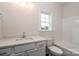 Bright bathroom featuring white cabinets, white countertops and a combined tub and shower at 3034 Buffet Ln, Monroe, NC 28110