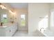 Bathroom with marble floors, double sink vanity and separate soaking tub at 3034 Buffet Ln, Monroe, NC 28110