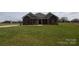 Traditional brick house with a green lawn, featuring symmetrically placed windows and simple landscaping for a neat appearance at 3034 Buffet Ln, Monroe, NC 28110