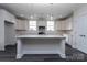 Modern kitchen featuring white cabinetry, an island with pendant lighting, and stainless steel appliances for a stylish look at 3034 Buffet Ln, Monroe, NC 28110