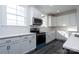 Bright kitchen with white cabinets, stainless steel appliances, quartz countertops, and dark wood floors, creating a clean design at 3034 Buffet Ln, Monroe, NC 28110