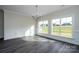 Bright living room featuring stylish gray floors, a modern chandelier, and large windows with a view at 3034 Buffet Ln, Monroe, NC 28110