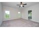 Relaxing main bedroom featuring neutral carpet, two windows that provide natural light, ceiling fan and ensuite at 3034 Buffet Ln, Monroe, NC 28110