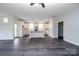 Bright open-concept living space with dark wood floors, white trim, and a kitchen with a large island, perfect for entertaining at 3034 Buffet Ln, Monroe, NC 28110
