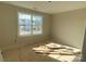 Simple bedroom with large window and wood flooring at 1017 Wandsworth Pl # Ken0108, Charlotte, NC 28215