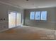 Bright room with sliding glass doors and wall-to-wall carpet at 1017 Wandsworth Pl # Ken0108, Charlotte, NC 28215