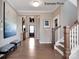 Spacious foyer with hardwood floors, a staircase, and large artwork at 1017 Wandsworth Pl # Ken0108, Charlotte, NC 28215