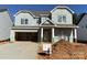 Two-story house with gray siding, attached garage, and landscaping at 1017 Wandsworth Pl # Ken0108, Charlotte, NC 28215