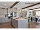 Modern kitchen with gray cabinets, a large island, and exposed wooden beams at 1017 Wandsworth Pl # Ken0108, Charlotte, NC 28215