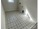 Laundry room with patterned floor tile and window at 1017 Wandsworth Pl # Ken0108, Charlotte, NC 28215