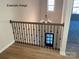 Elegant staircase with black metal railing and wood flooring at 1017 Wandsworth Pl # Ken0108, Charlotte, NC 28215