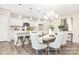 Dining room featuring white chairs, a wooden table, pendant lights, and an open view into the kitchen at 1027 Freeman View Dr # 151P, Albemarle, NC 28001