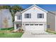 Two-story home with gray stone accents, white siding, and an attached two-car garage at 1027 Freeman View Dr # 151P, Albemarle, NC 28001