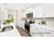 Well-lit kitchen showcasing white cabinets, stainless steel appliances, and gray subway tile backsplash at 1027 Freeman View Dr # 151P, Albemarle, NC 28001