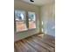 Simple bedroom with light wood flooring and two large windows at 1176 Greenheather Dr, Salisbury, NC 28147