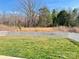 Fenced back yard with green grass and view of the trees at 126 E Northstone Rd, Mooresville, NC 28115