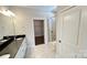 Bathroom featuring dual vanities, granite countertops, and glass-enclosed shower at 126 E Northstone Rd, Mooresville, NC 28115