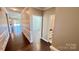 Hallway leading to spacious living area and bathrooms with hardwood floors and white trim at 126 E Northstone Rd, Mooresville, NC 28115