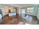 Open-concept living area with hardwood floors, a kitchen island, and a sliding glass door to the backyard at 126 E Northstone Rd, Mooresville, NC 28115