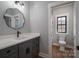 Bathroom featuring gray cabinets, solid countertop, and walk-in marble tiled shower at 229 Golf Course Rd, Maiden, NC 28650