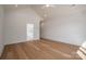 A bedroom with an ensuite bathroom features hardwood floors, white walls, and a ceiling fan at 229 Golf Course Rd, Maiden, NC 28650