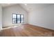 A bright bedroom features hardwood floors, white walls, and a large window for natural light at 229 Golf Course Rd, Maiden, NC 28650