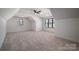 Upstairs bonus room with carpet, ceiling fan, and windows at 229 Golf Course Rd, Maiden, NC 28650