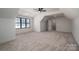 Upstairs bonus room with carpet, ceiling fan, windows, and a door at 229 Golf Course Rd, Maiden, NC 28650