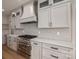 Close up of the kitchen with stainless steel appliances, range, custom hood, and cabinetry at 229 Golf Course Rd, Maiden, NC 28650