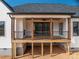 A rear view of this home featuring a covered back porch with stained wood beams at 229 Golf Course Rd, Maiden, NC 28650