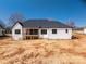 A full back view of this home that features a covered back porch at 229 Golf Course Rd, Maiden, NC 28650