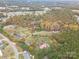 Aerial view of land featuring a house with a red roof surrounded by trees in autumn at 231 Cheek Rd, Clover, SC 29710