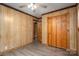 Cozy bedroom features wood-paneled walls, a ceiling fan, and a closet for ample storage at 231 Cheek Rd, Clover, SC 29710