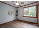 Bright bedroom features wood trim, a ceiling fan, and a view of the landscape from a large window at 231 Cheek Rd, Clover, SC 29710