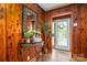 Warm entryway with wood paneling, a decorative mirror, and a view to the outside at 231 Cheek Rd, Clover, SC 29710