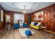 Stylish living room with hardwood floors, wood-paneled walls and natural light at 231 Cheek Rd, Clover, SC 29710